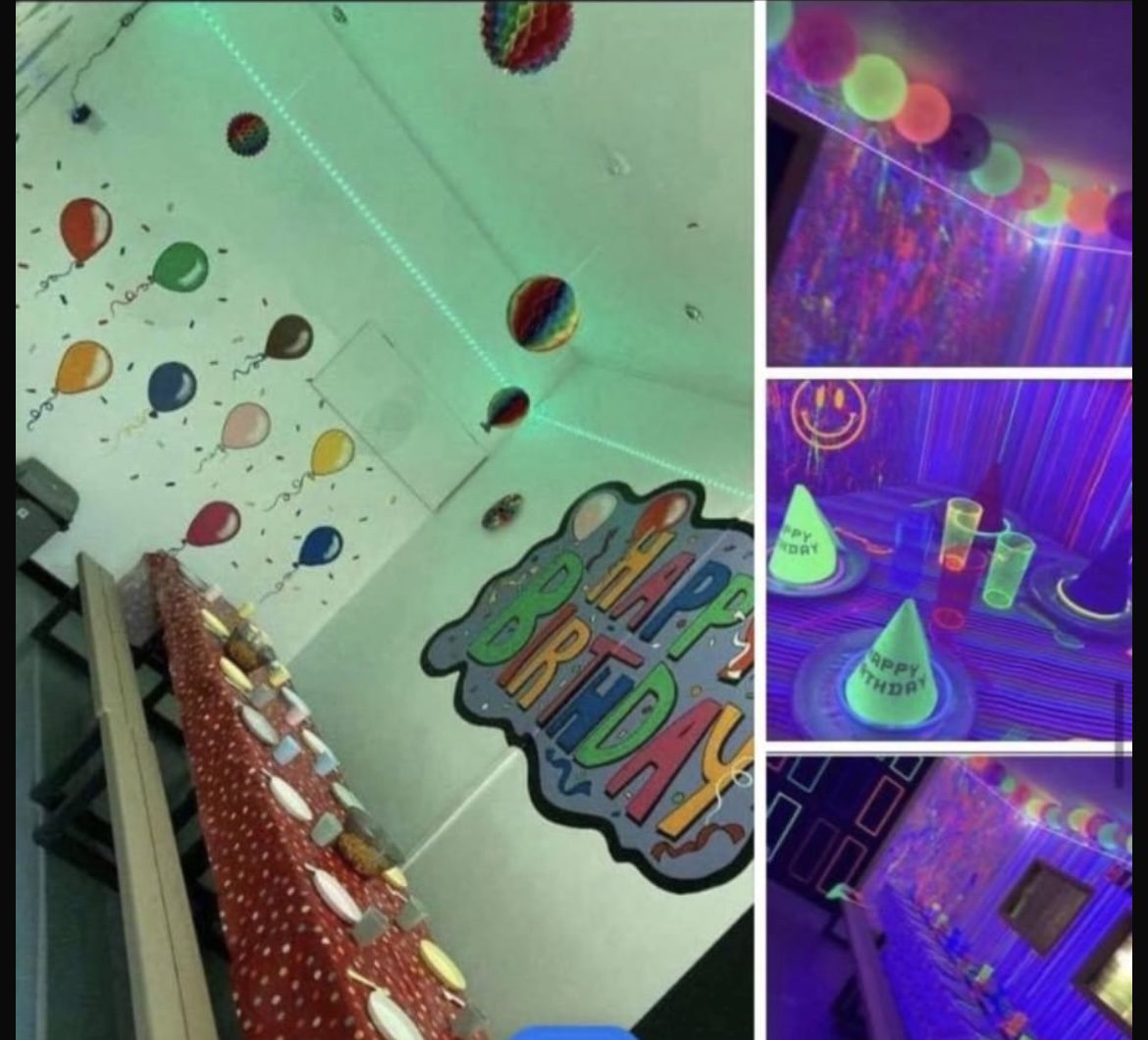 A room filled with balloons and lights in the dark.